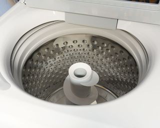 An empty open top load washing machine