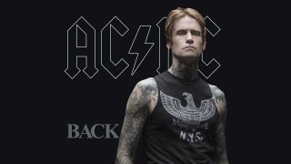 Josh Todd standing in front of the Back In Black artwork