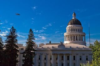 Space shuttle Endeavour and its carrier aircraft fly low over the California State Capitol Building in Sacramento on Sept. 21, 2012, during a state-wide tour over California on the way to Los Angeles.