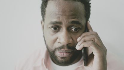 Worried man talking on the phone