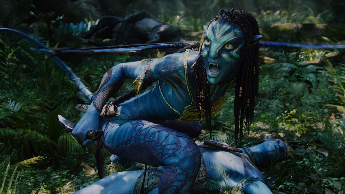A blue human-like creature is wielding a knife and looks to their side menacingly while another blue creature lays underneath them.