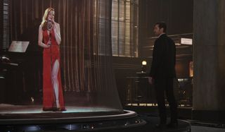 Rebecca Ferguson sings while Hugh Jackman watches in Reminiscence.