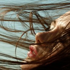 Best products for thin hair: woman with hair blowing in wind