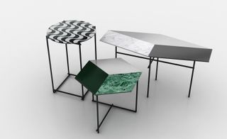 View of a round table and two geometric tables from O CÉU featuring marble and ripple-like effects on top in green, white, grey and black