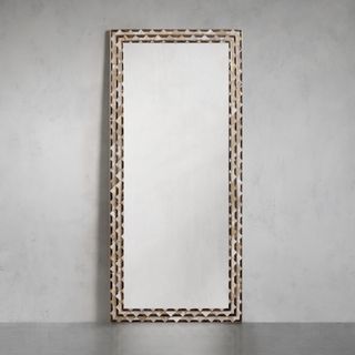 Alaia Mirror against a gray wall.