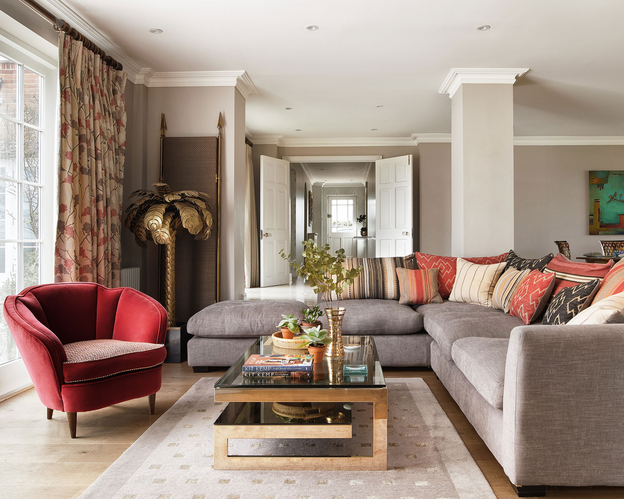 Living room with L-shaped sofa and red chair