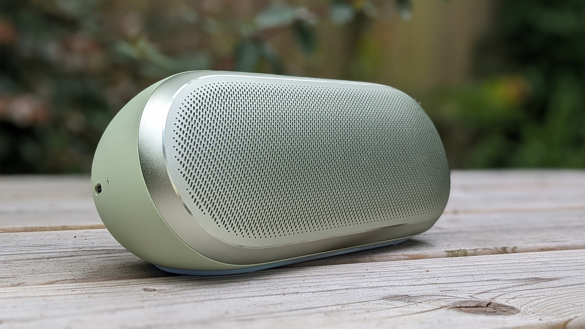 Harman Kardon Luna 2 wireless speaker on wooden outdoor table