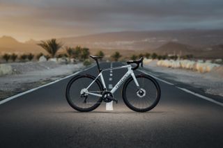 Wilier Filante Hybrid electric bike in white on a background of road stretching out into desert 