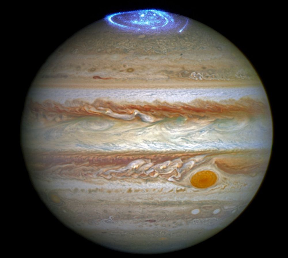 A combined image of Jupiter take by the Hubble Space Telescope in 2014 in optical light and an observations of its auroras in ultraviolet light, taken in 2016.