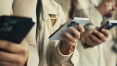 People holding iPhones in a queue