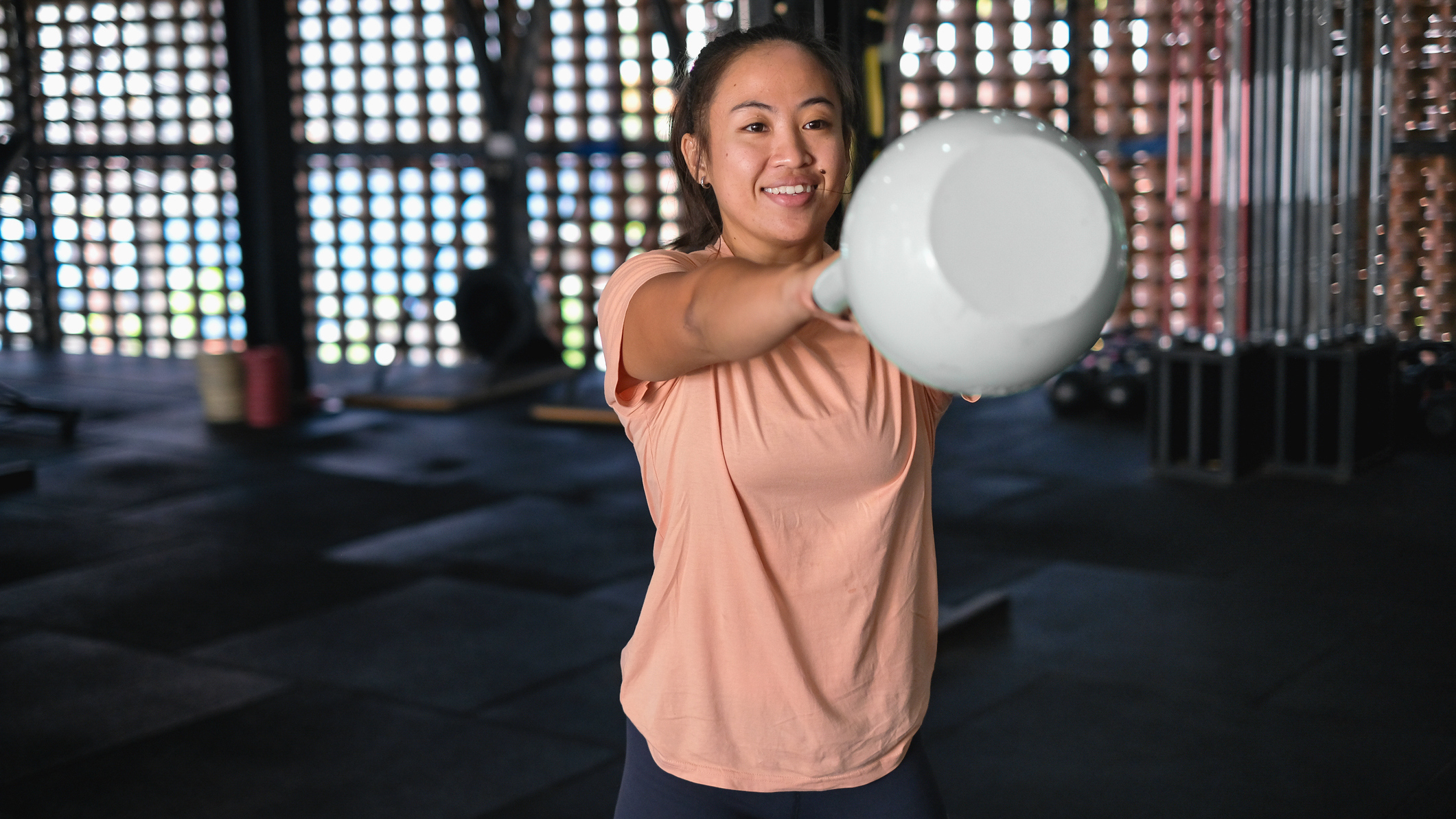Woman exercising with kettlebell in gym
