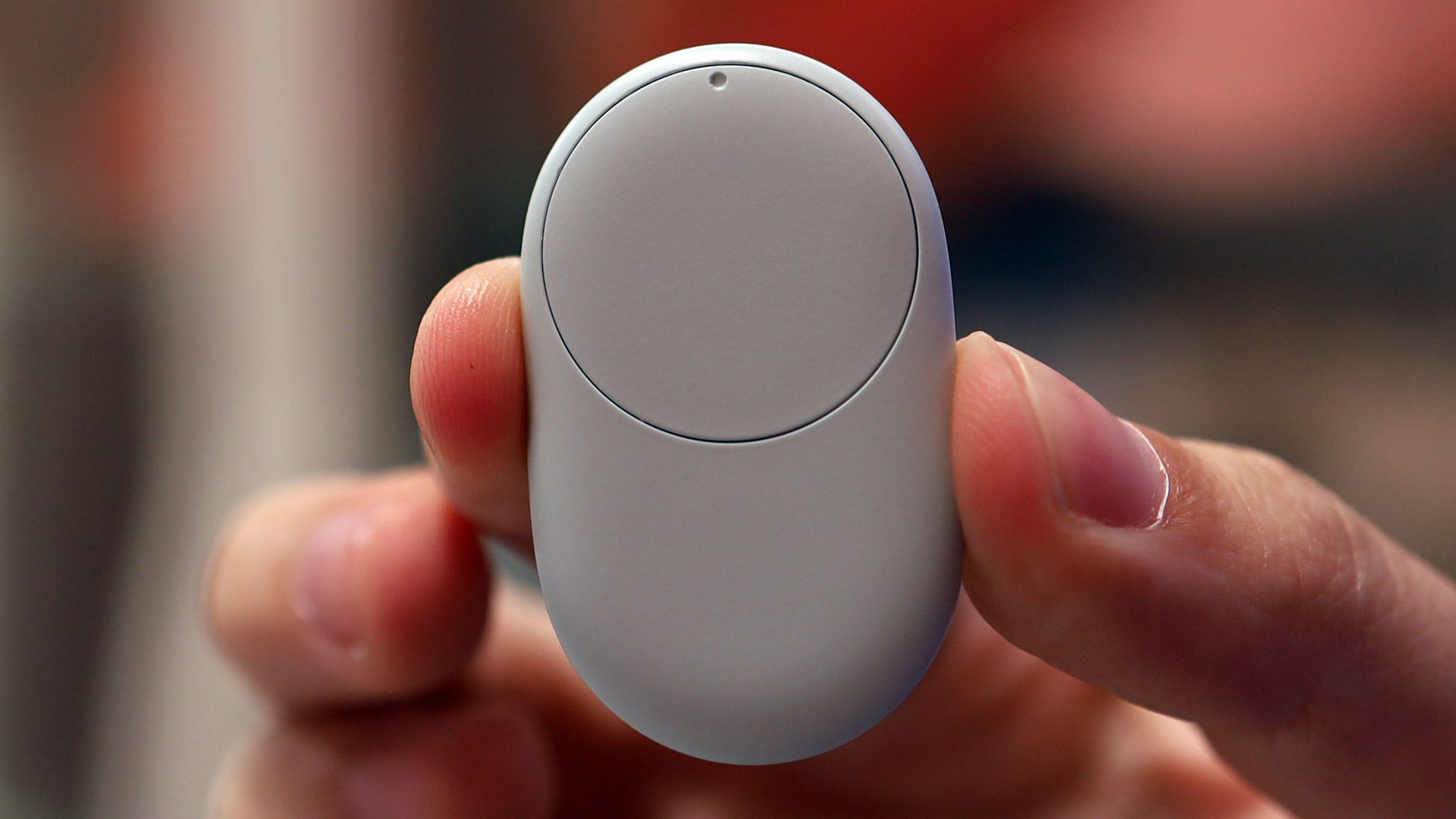 A hand holding the Google Pixel Tag