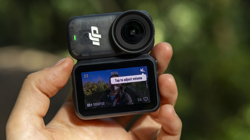 A female photographer holding the DJI Osmo Nano action camera