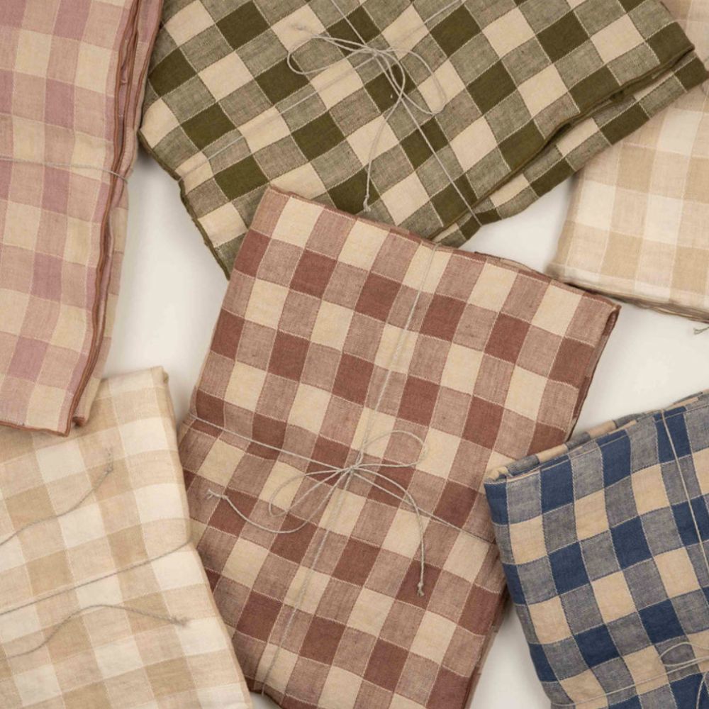 folded gingham tablecloths in different colors