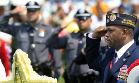 Veteran Gerald Williams salutes during a Memorial Day ceremony at Brig. General William C. Doyle Cemetery in Wrightstown, N.J.