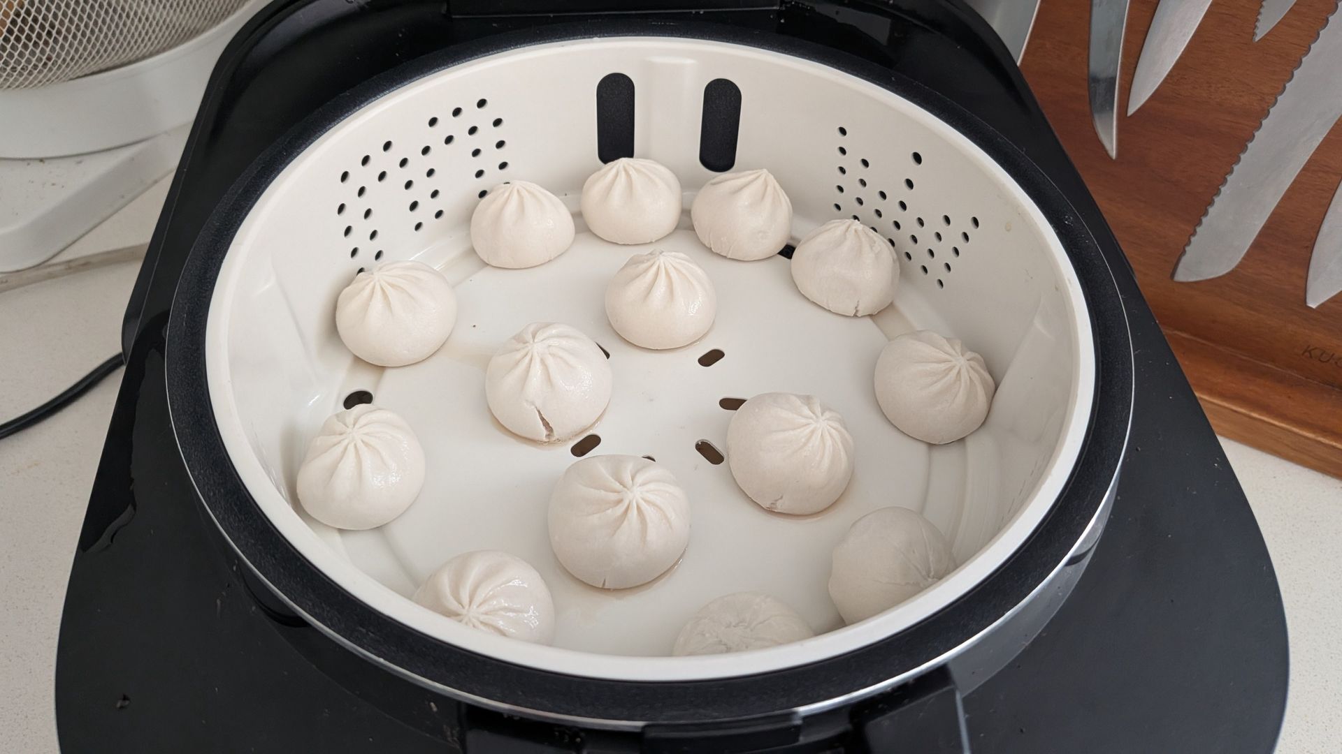 Midea 5L Induction Rice Cooker with some soup dumplings cooked in its included steaming basket