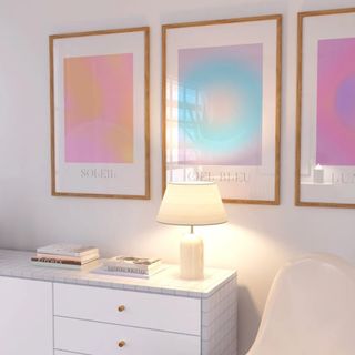 Gradient artwork framed above a lamp and table