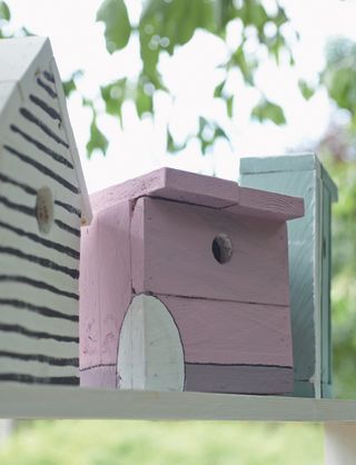 Pink bird house from Pallet wood projects for outdoor spaces book by CICO Books