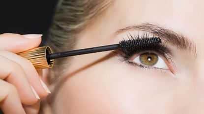 woman applying mascara