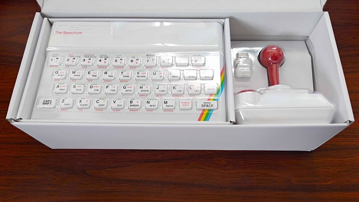 The Spectrum White Edition box with open lid revealing system, joystick, and USB Microdrive.