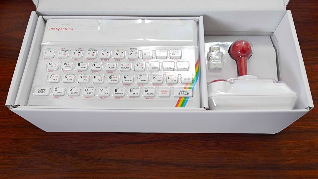 The Spectrum White Edition box with open lid revealing system, joystick, and USB Microdrive.