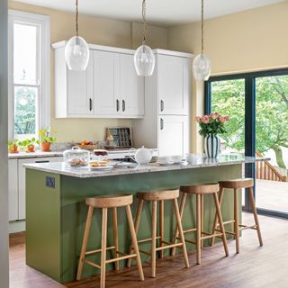 Green and white two tone kitchen with kitchen island