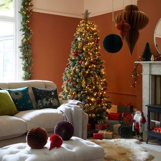 Christmas tree in terracotta living room with paper decorations