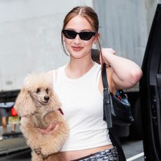 Lola Tung styled a scarf as a belt with a black leather Coach bag in NYC