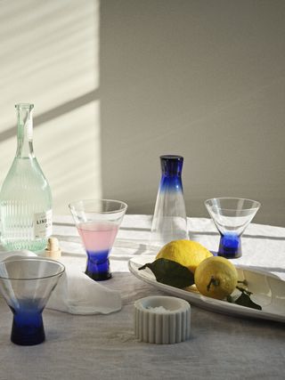 A large table with different-colored glasses