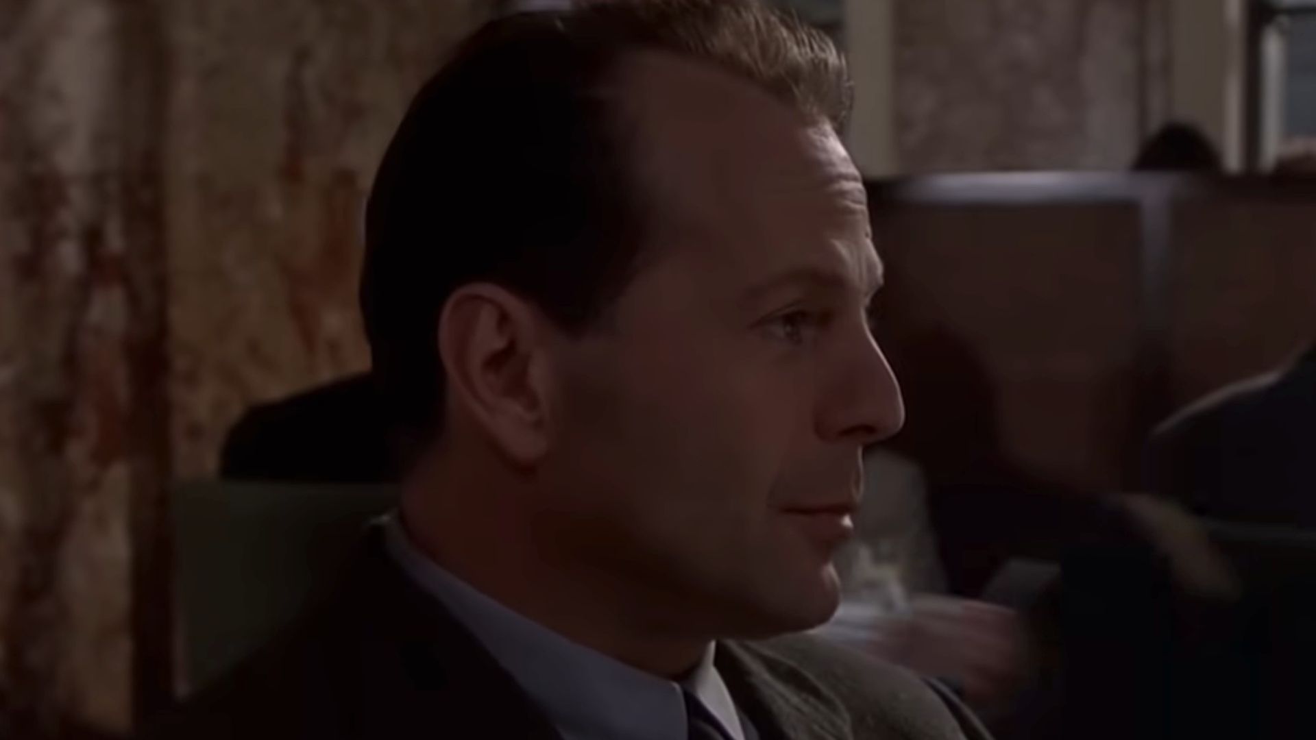 A close up of Bruce Willis in a suit and tie, in the dinner scene in The Sixth Sense