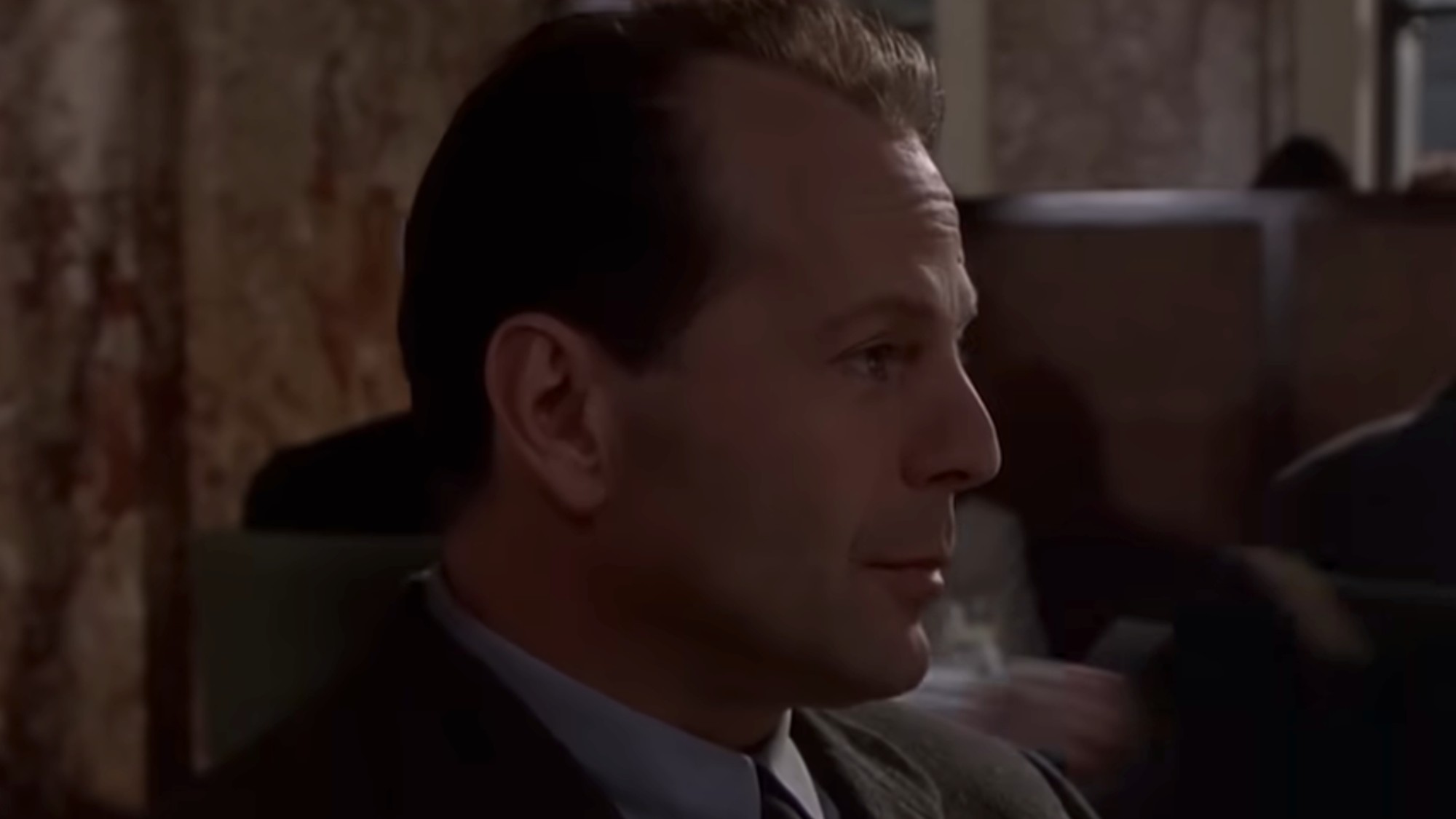 A close up of Bruce Willis in a suit and tie, in the dinner scene in The Sixth Sense