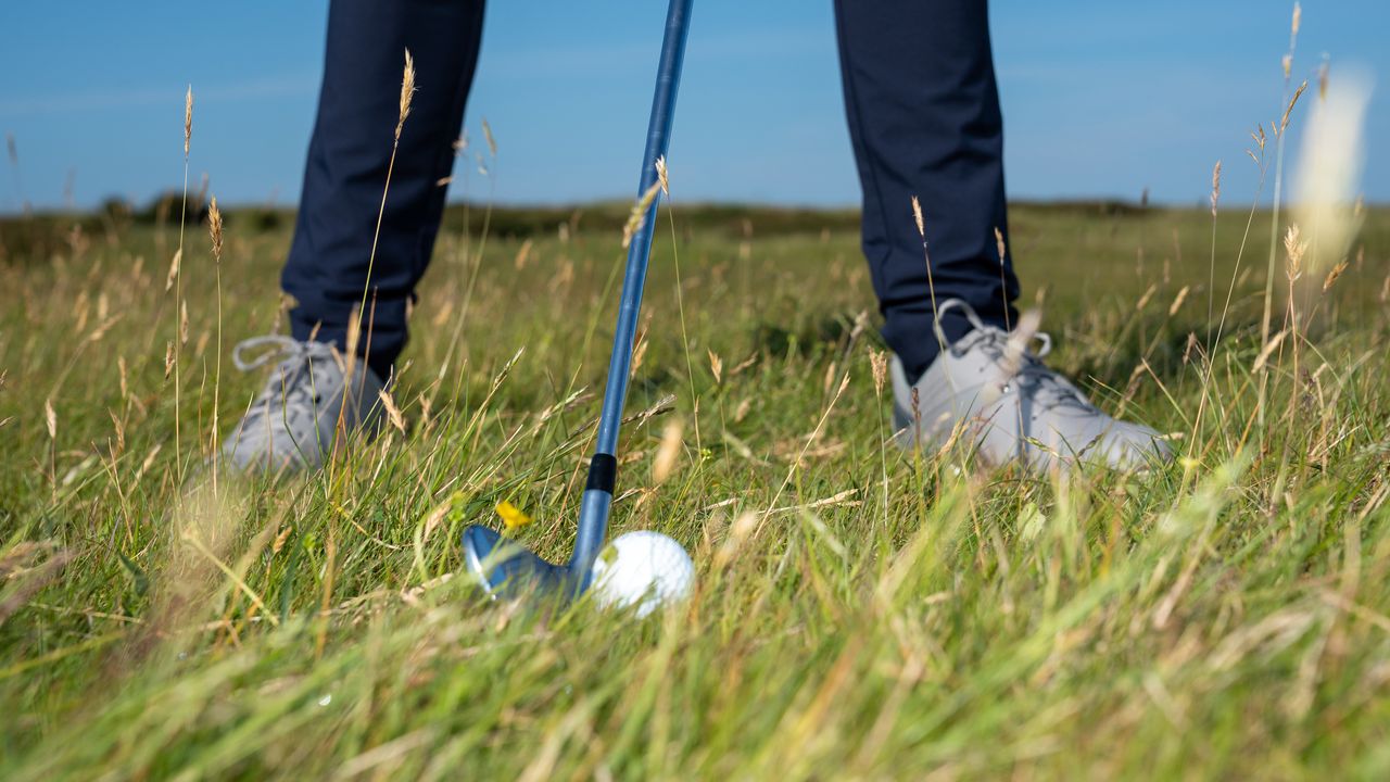 How to pick the right club in the rough: A golfer addressing a golf ball that&#039;s in the rough on the 13th hole of Royal Troon