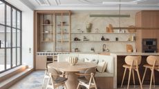 kitchen diner with lights over the island and in the stairs leading up the the Crittal doors