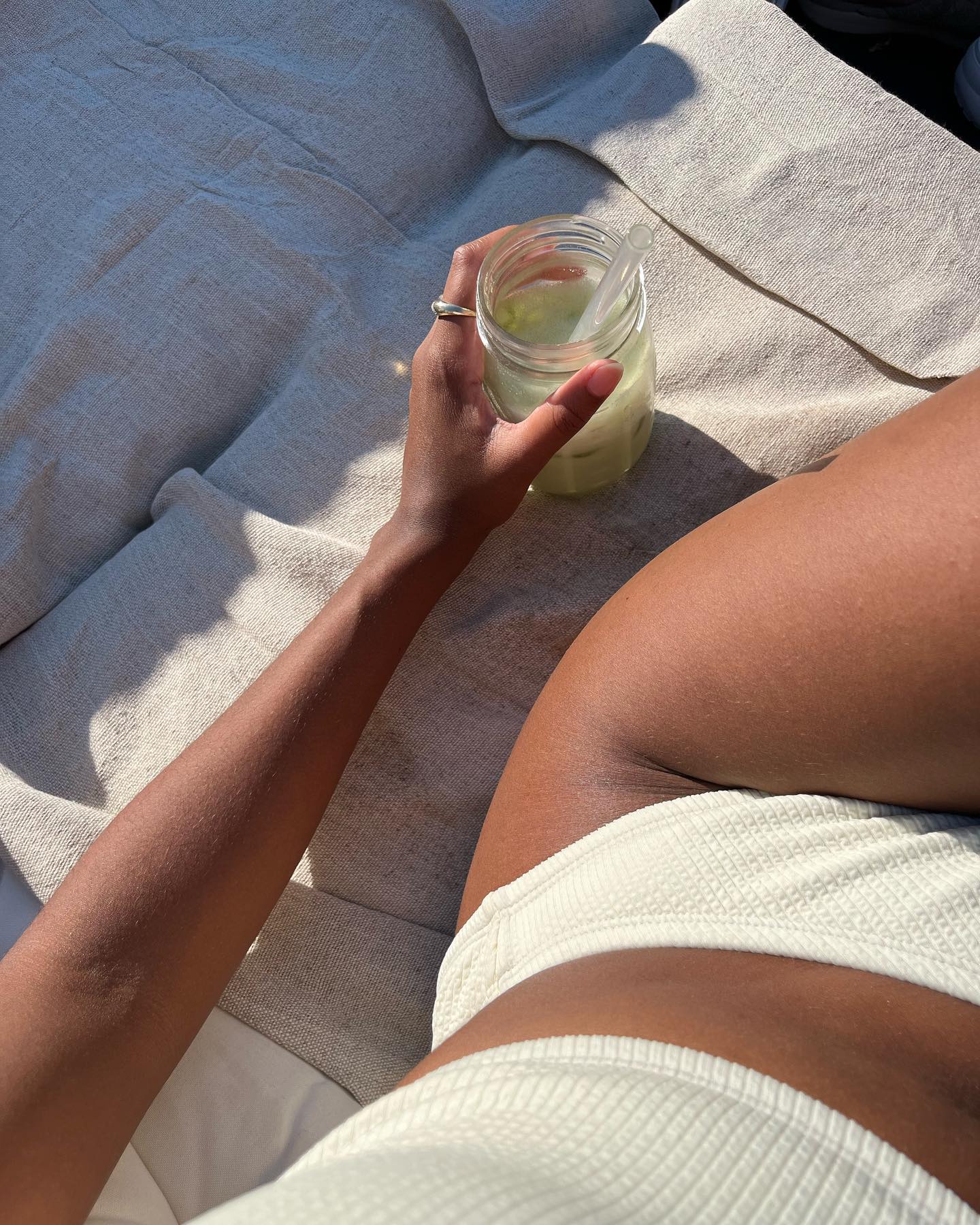 Claire Most lays poolside with hydrated, healthy skin