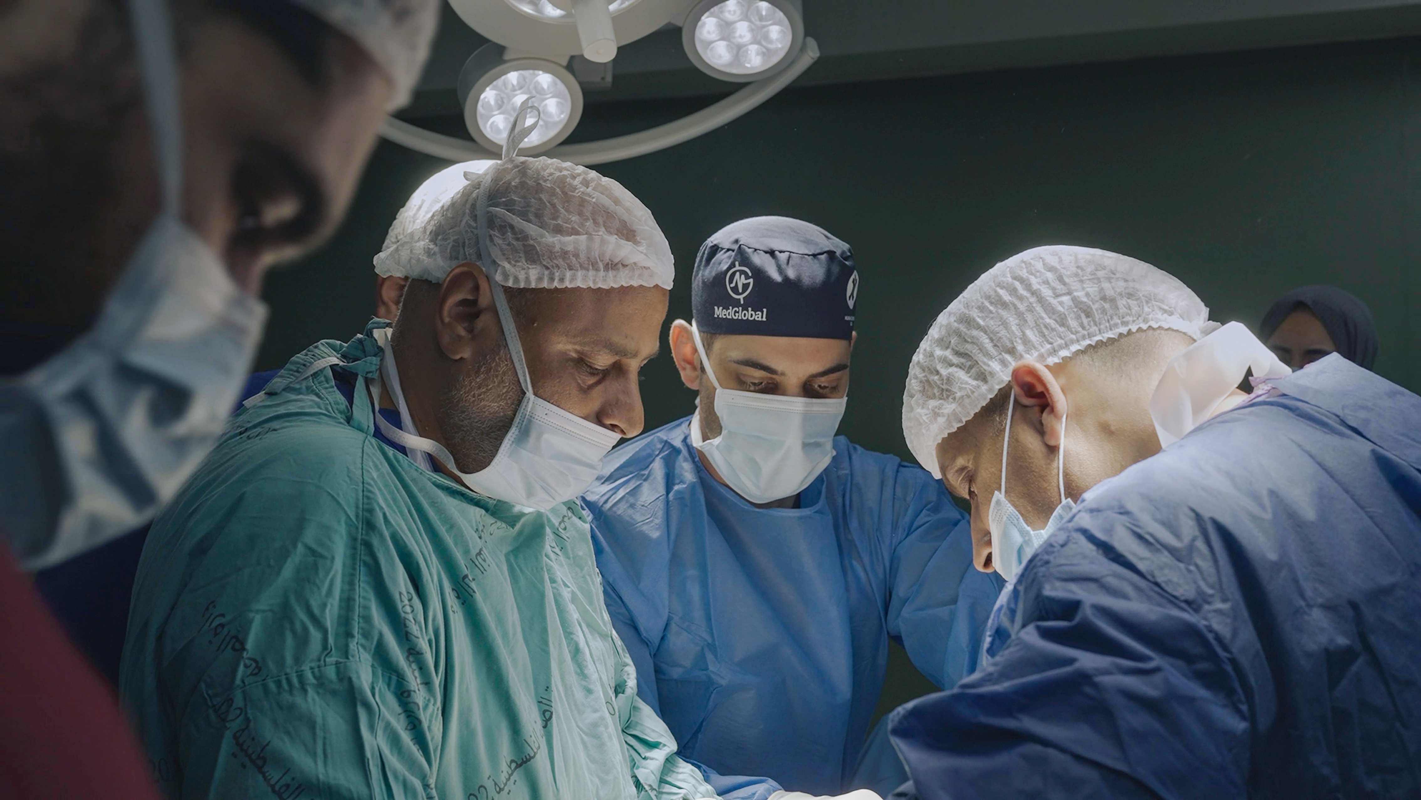 a still from the documentary american doctor of three surgeons in scrubs performing surgery
