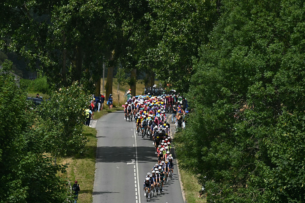 The pack of riders (peloton) cycles during the 3rd stage of the 112th edition of the Tour de France cycling race, 178.3 km between Valenciennes and Dunkerque (Dunkirk), Northern France, on July 7, 2025. (Photo by Loic VENANCE / AFP) (Photo by LOIC VENANCE/AFP via Getty Images)
