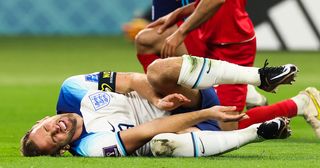 Harry Kane #9 of England reacts to an injury during the FIFA World Cup Qatar 2022 Group B match between England and IR Iran at Khalifa International Stadium on November 21, 2022 in Doha, Qatar.