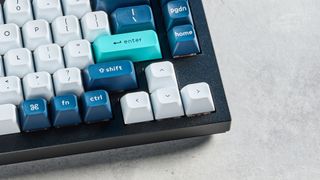 the keychron q12 max southpaw keyboard in navy blue with white and teal keycaps and red jupiter gateron switches