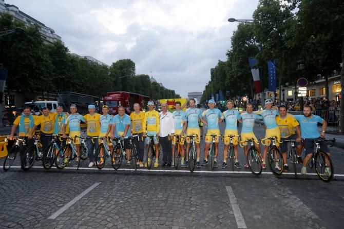 Astana celebrates in Paris. The team had planned to ride the final stage in yellow knicks but were forced by ASO to change back to their standard team outfits