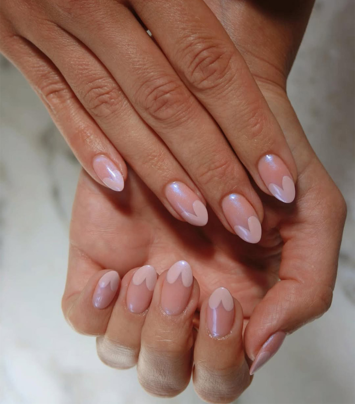 A manicure with chrome pink heart tips by Imarni.