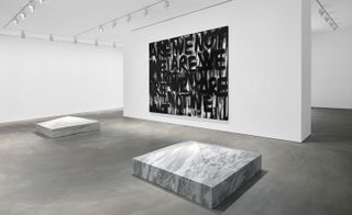Black and white image of. gallery with marble on the floor and a graffiti image