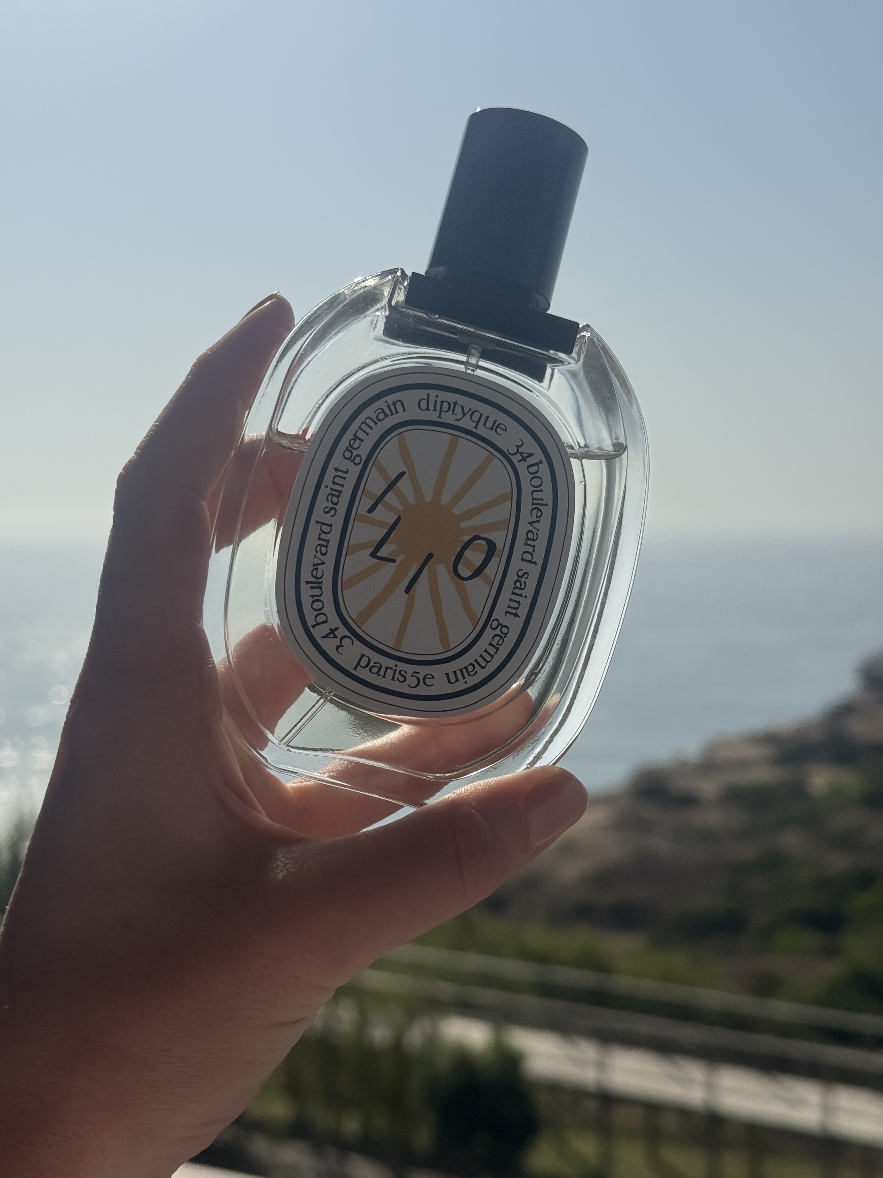 Eleanor holding a bottle of Diptyque Ilio