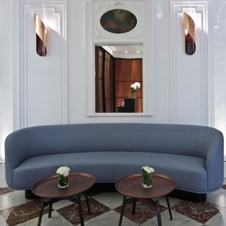 Seating space with grey sofa and white flower vase hotel Vernet,Paris