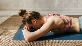 Woman face down on exercise mat