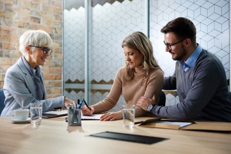 A financial adviser helps a couple manage their finances
