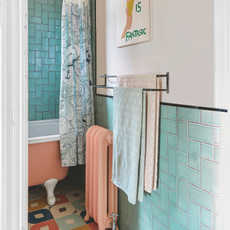 Pink and blue towel on rail in pink and blue bathroom