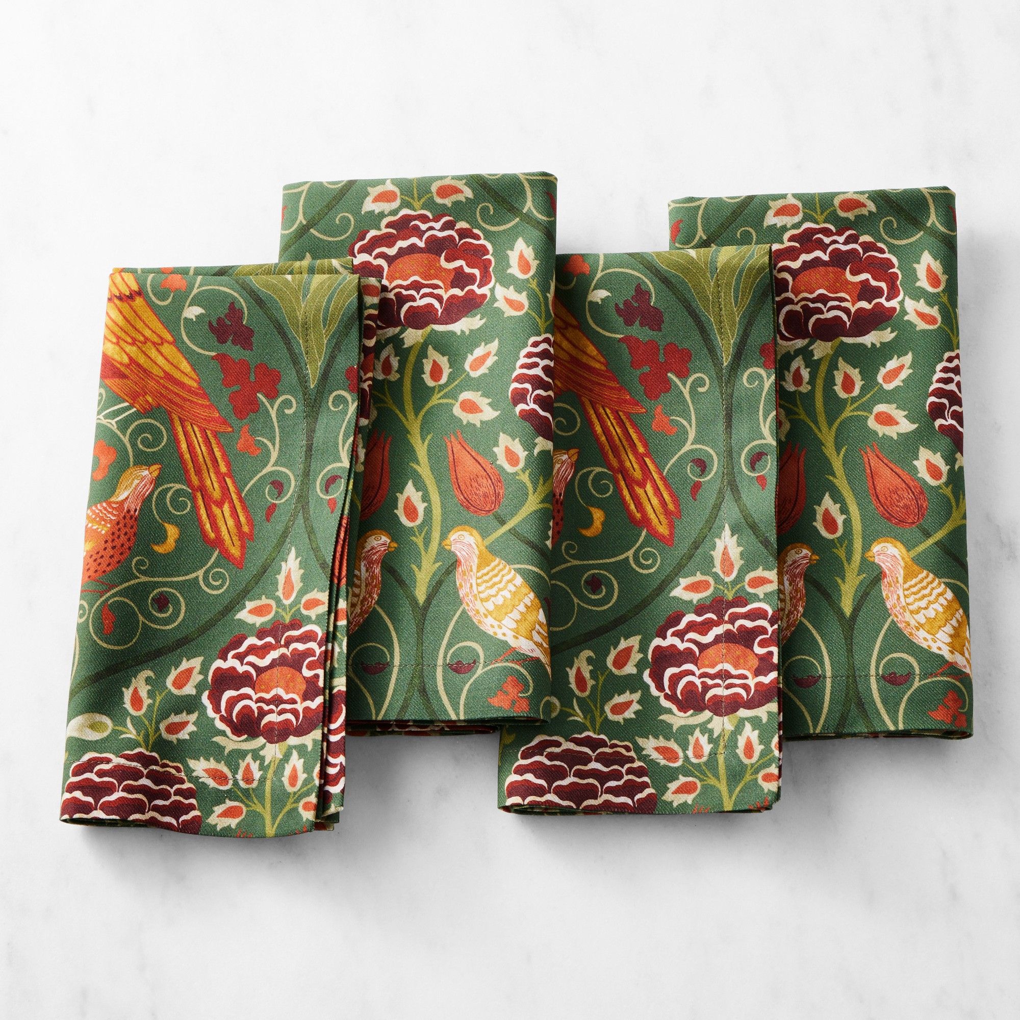 Green napkins with red, orange and yellow fall-inspired botanical prints