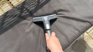Cleaning black garden cushions with a spot washer