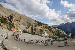 The peloton climbs the Izoard during stage 18 at the Tour de France