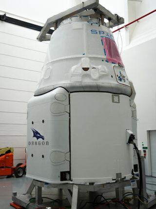 SpaceX’s robotic Dragon cargo capsule receives its final processing ahead of its planned April 13, 2015 launch toward the International Space Station.